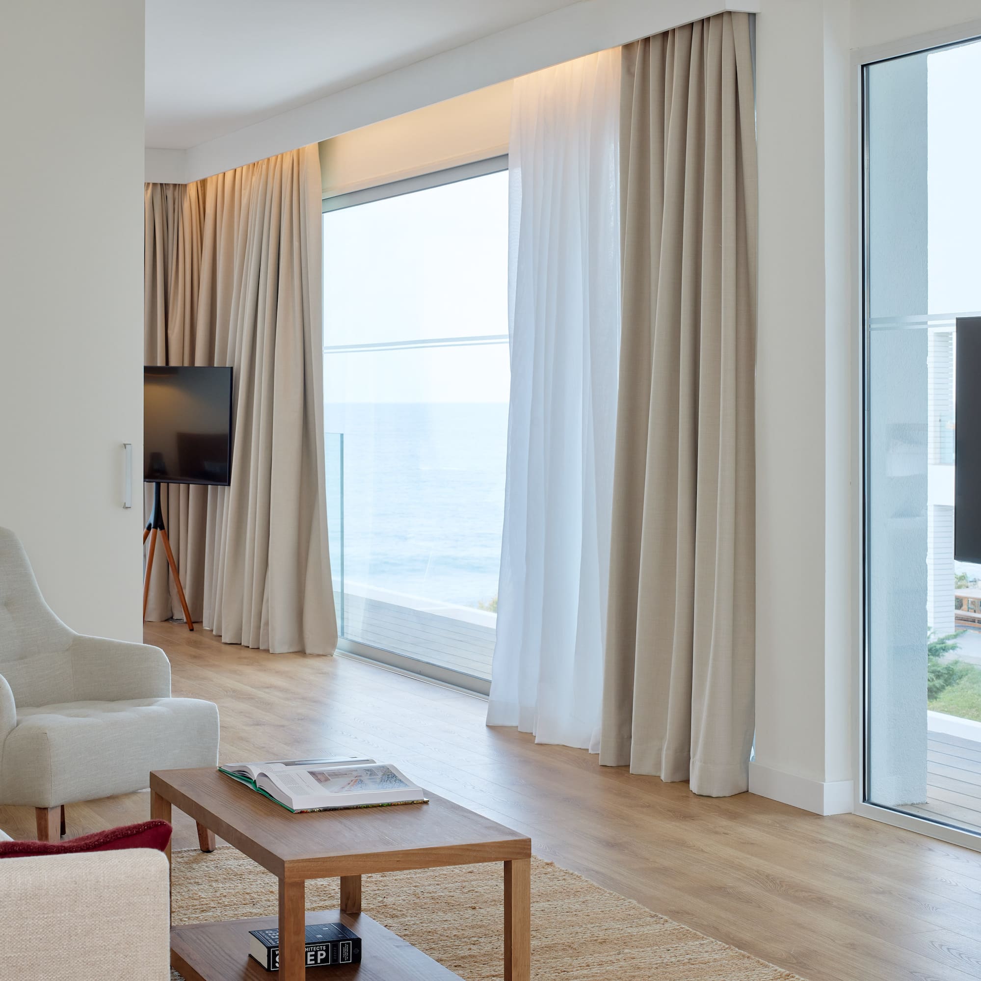 a living room with a television and a large window