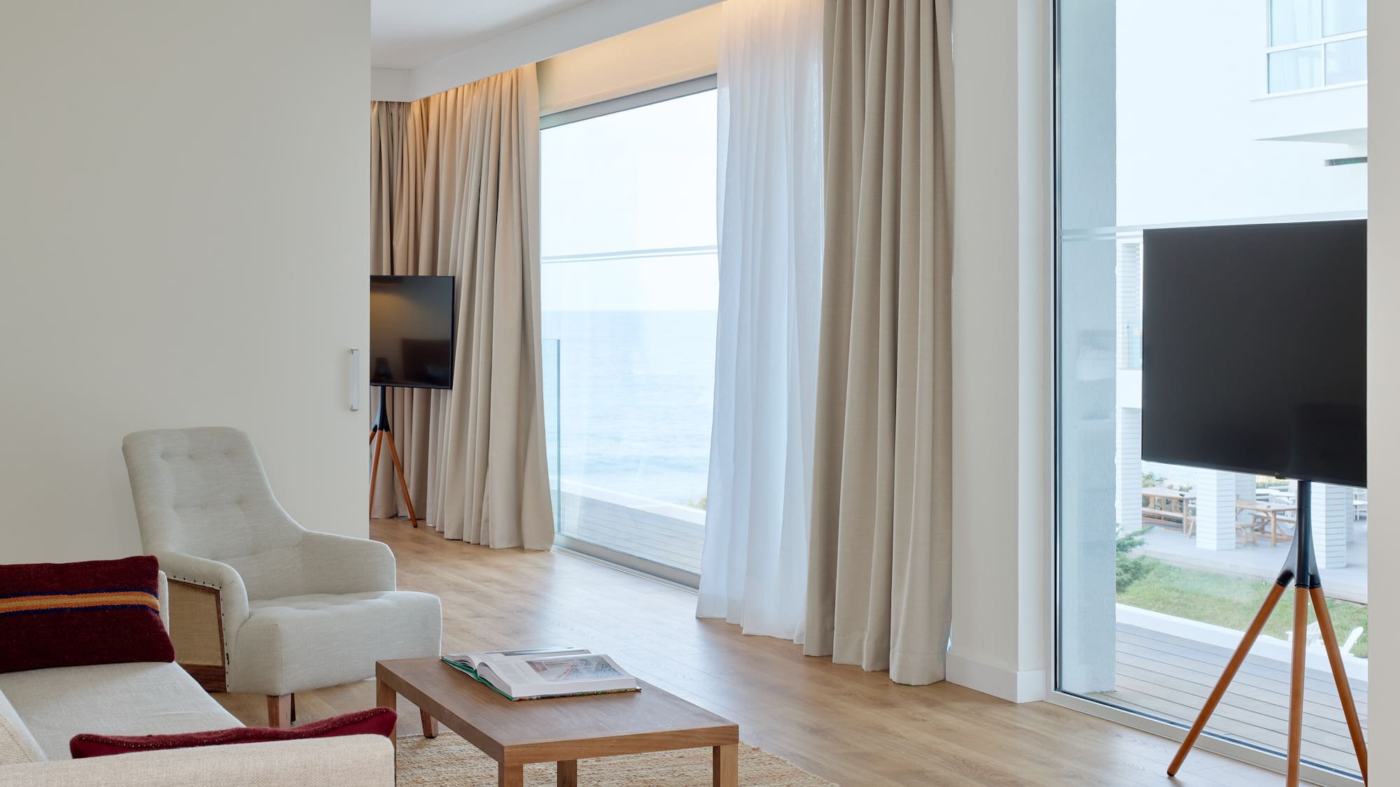 a living room with a television and a large window