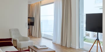 a living room with a television and a large window