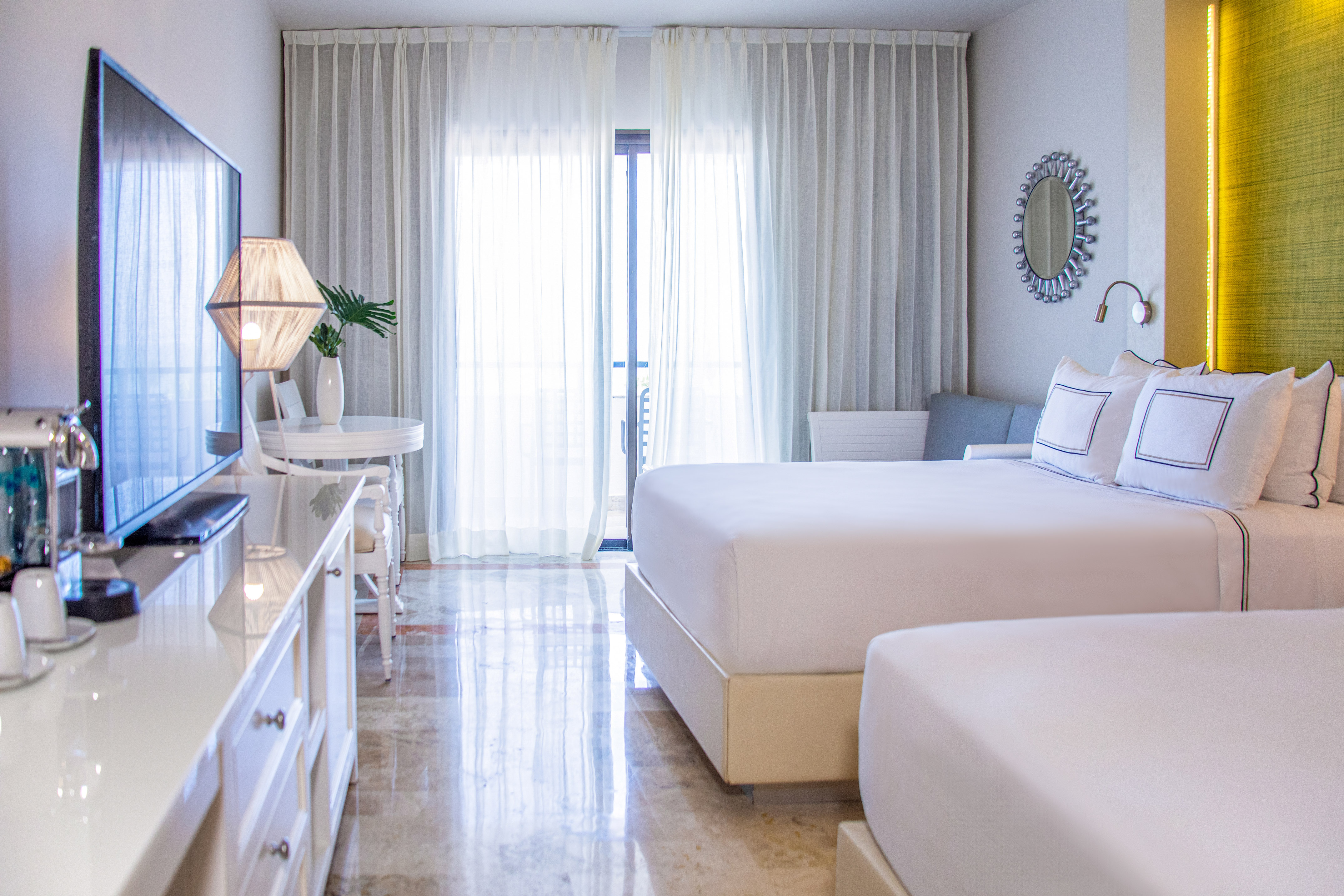 a bedroom with two beds and a television