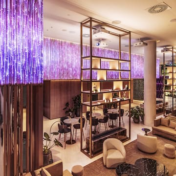 a living room with purple couches and a table