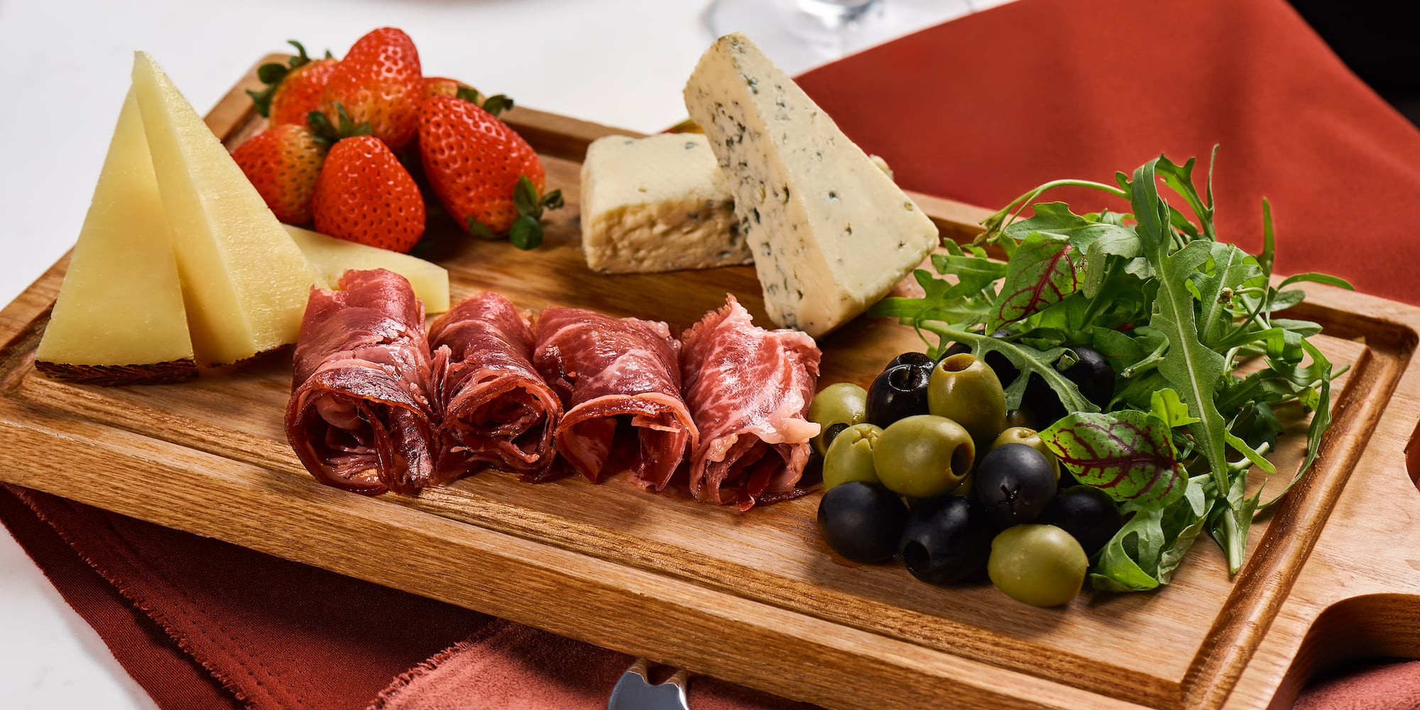 a wooden board with food on it