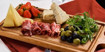 a wooden board with food on it