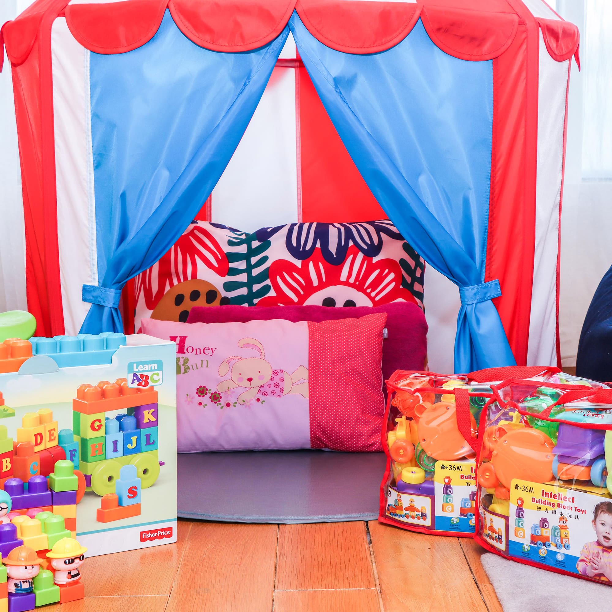 a child's room with a tent and toys