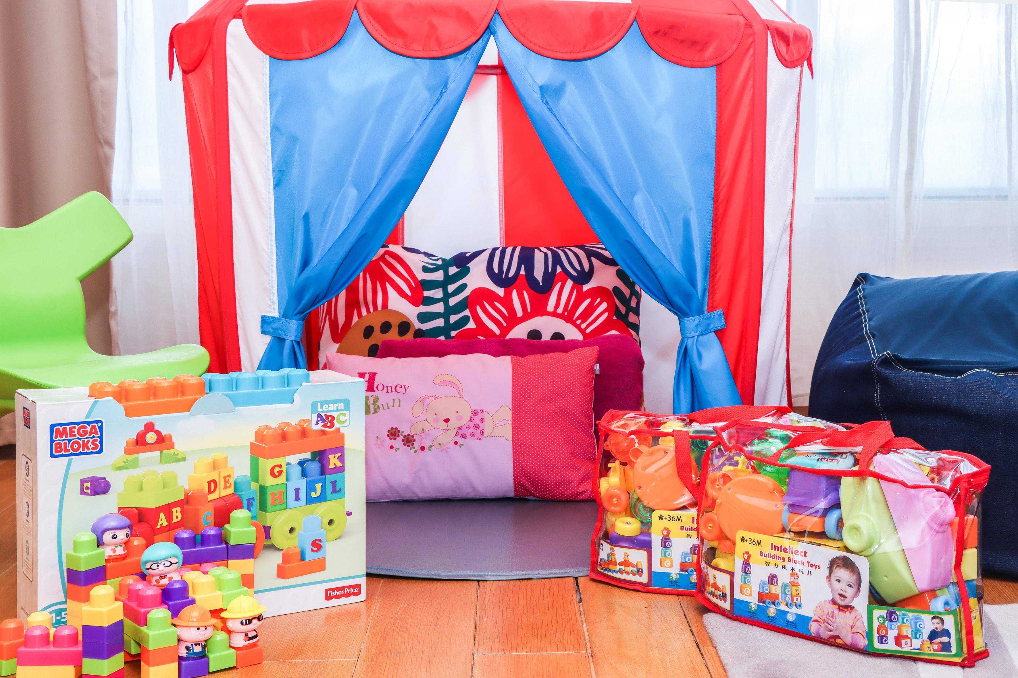 a child's room with a tent and toys