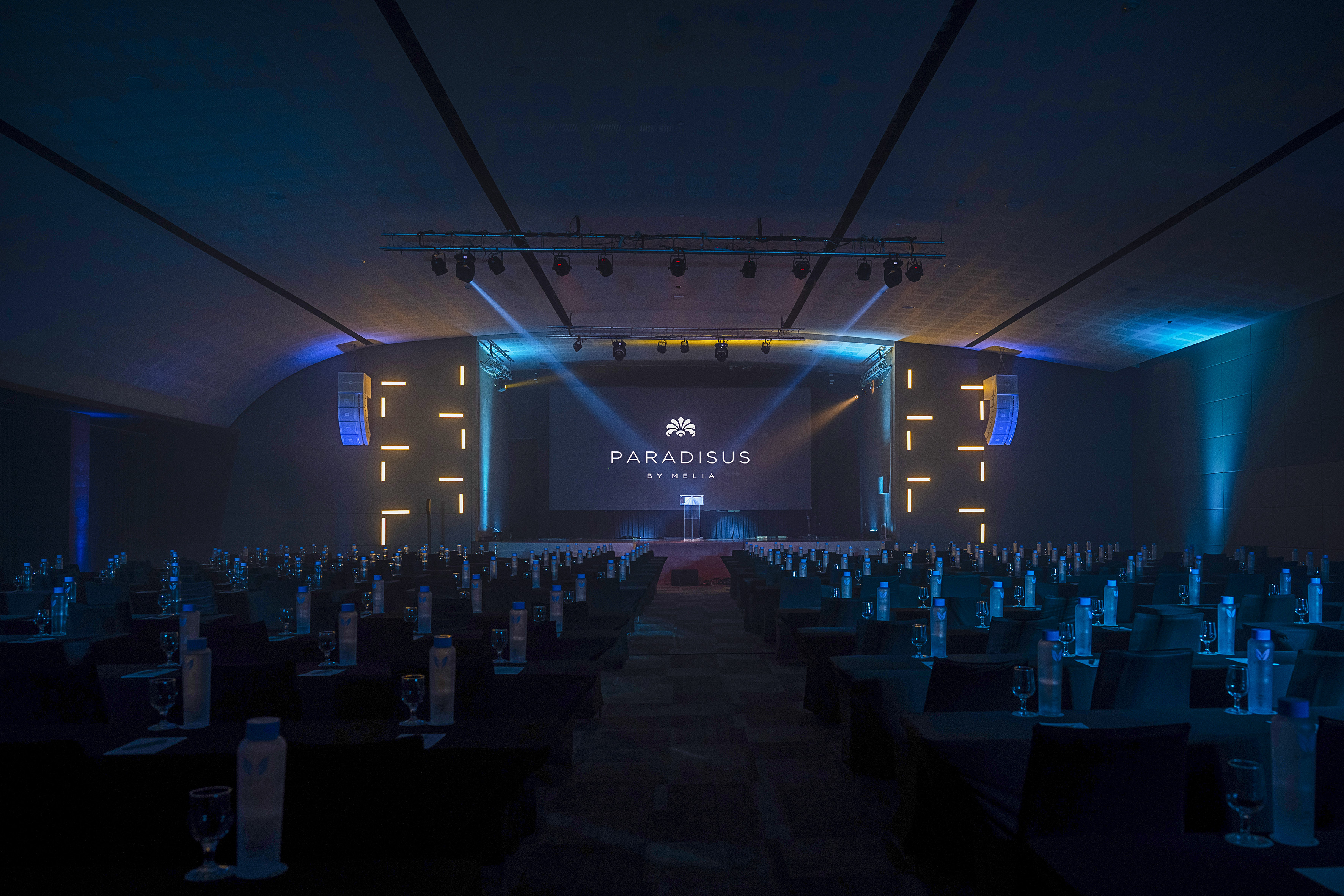 Paradisus by Melia conference room with stage, seating, and event lighting.