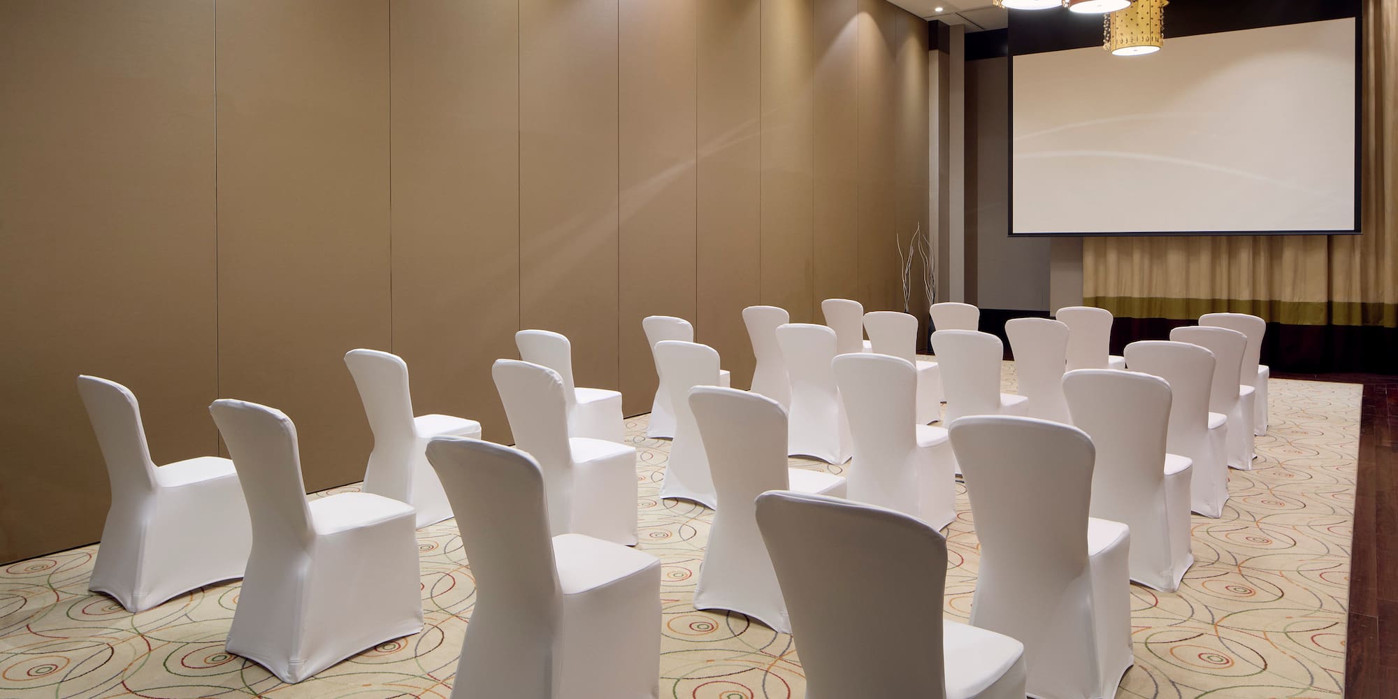 a room with chairs and a projector screen