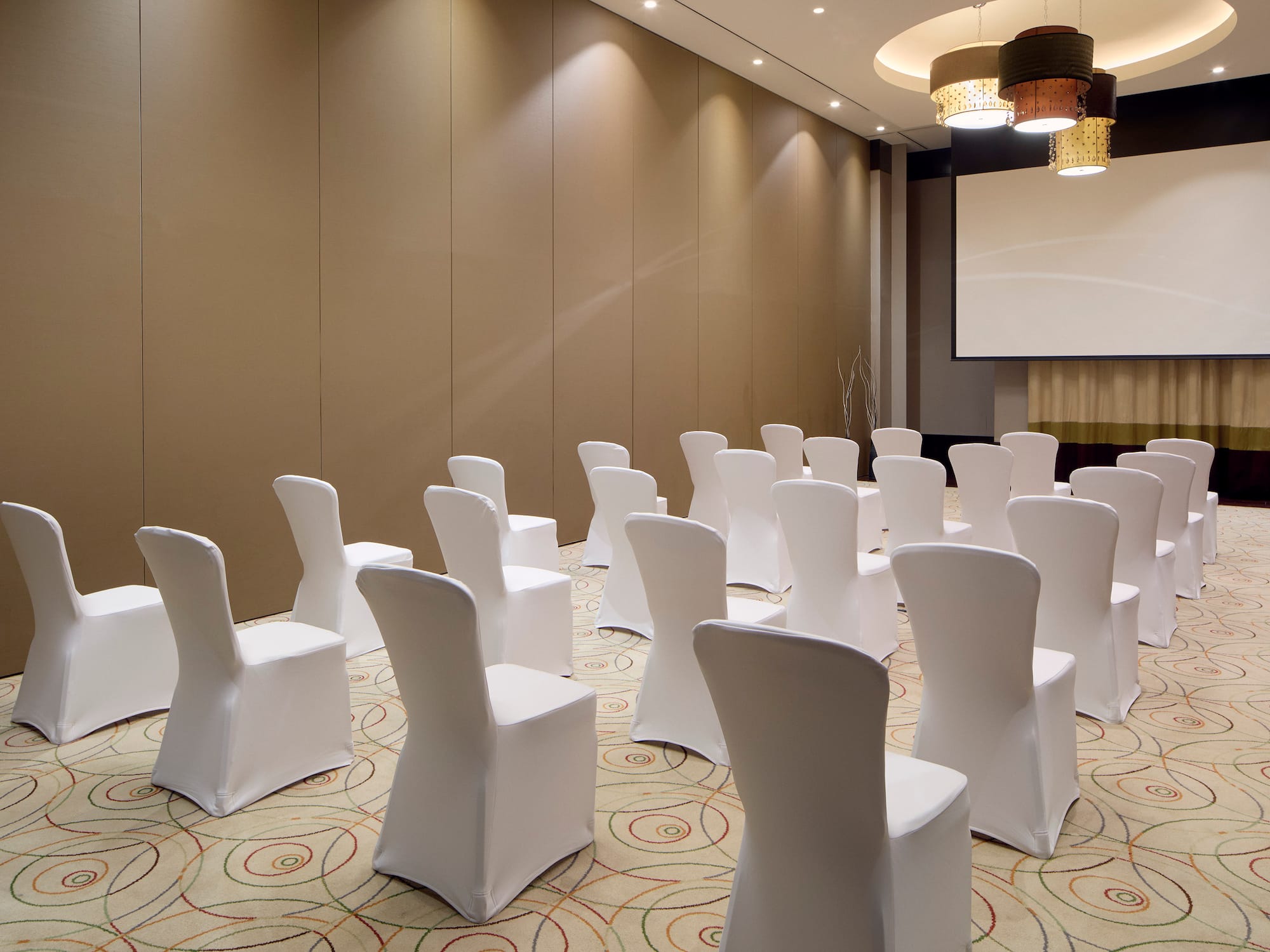 a room with chairs and a projector screen