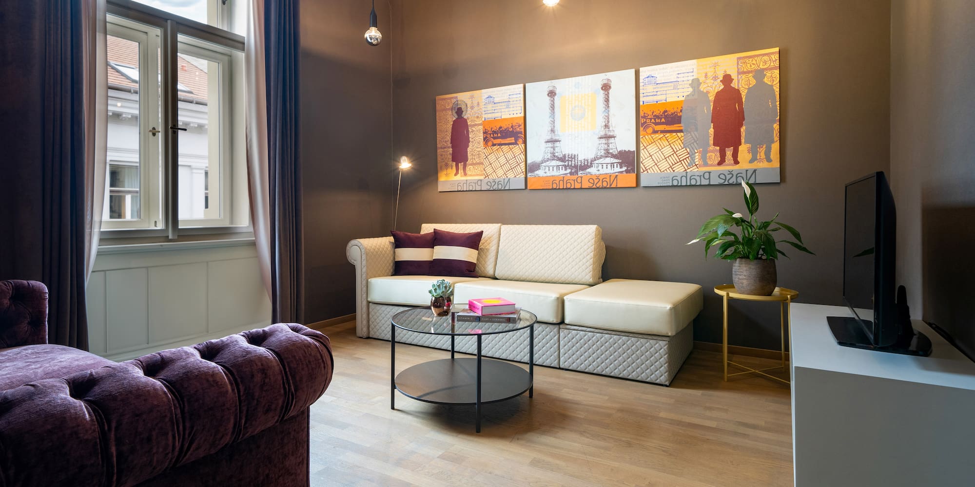 a living room with couch and art on the wall