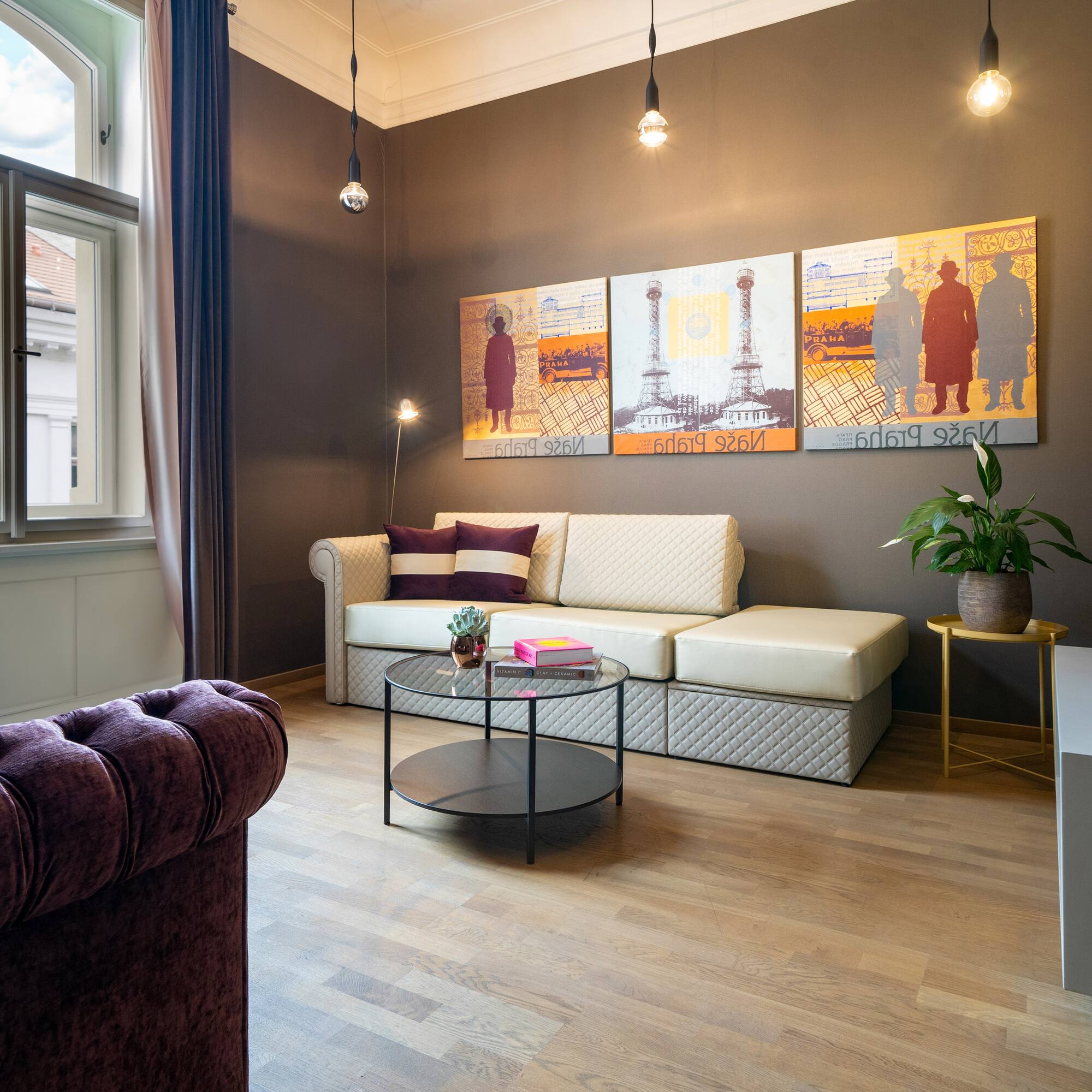 a living room with couch and art on the wall