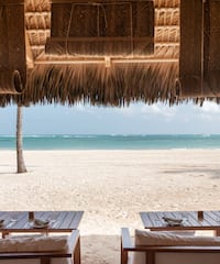 a beach with tables and chairs