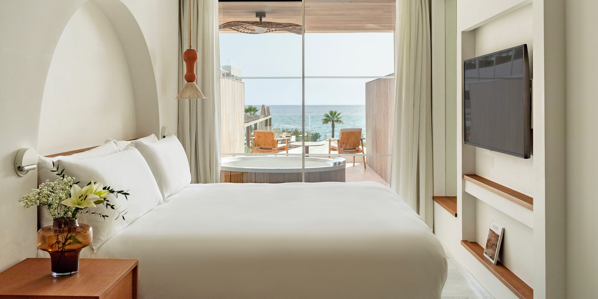 a room with a bed and a television