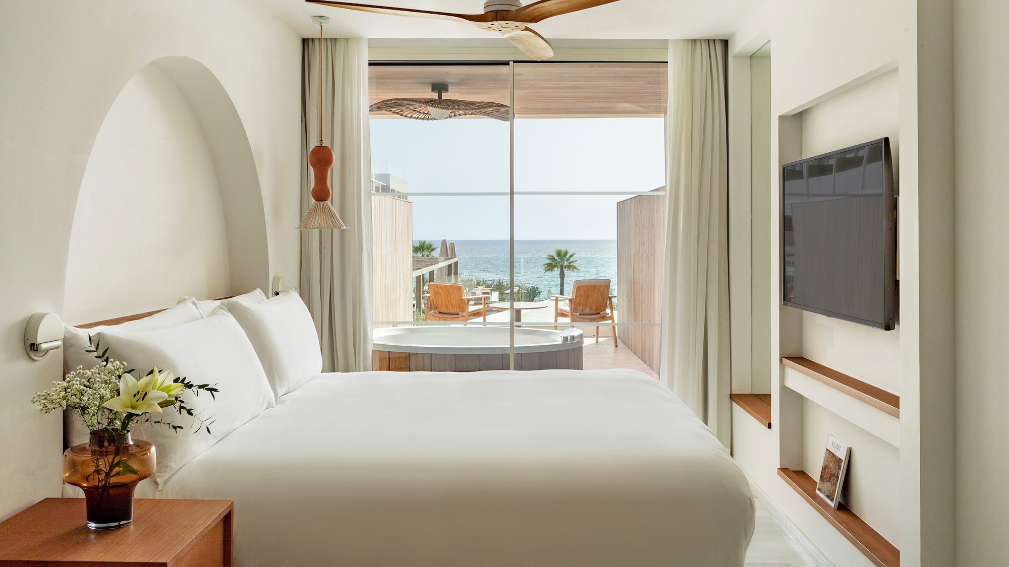 a room with a bed and a television