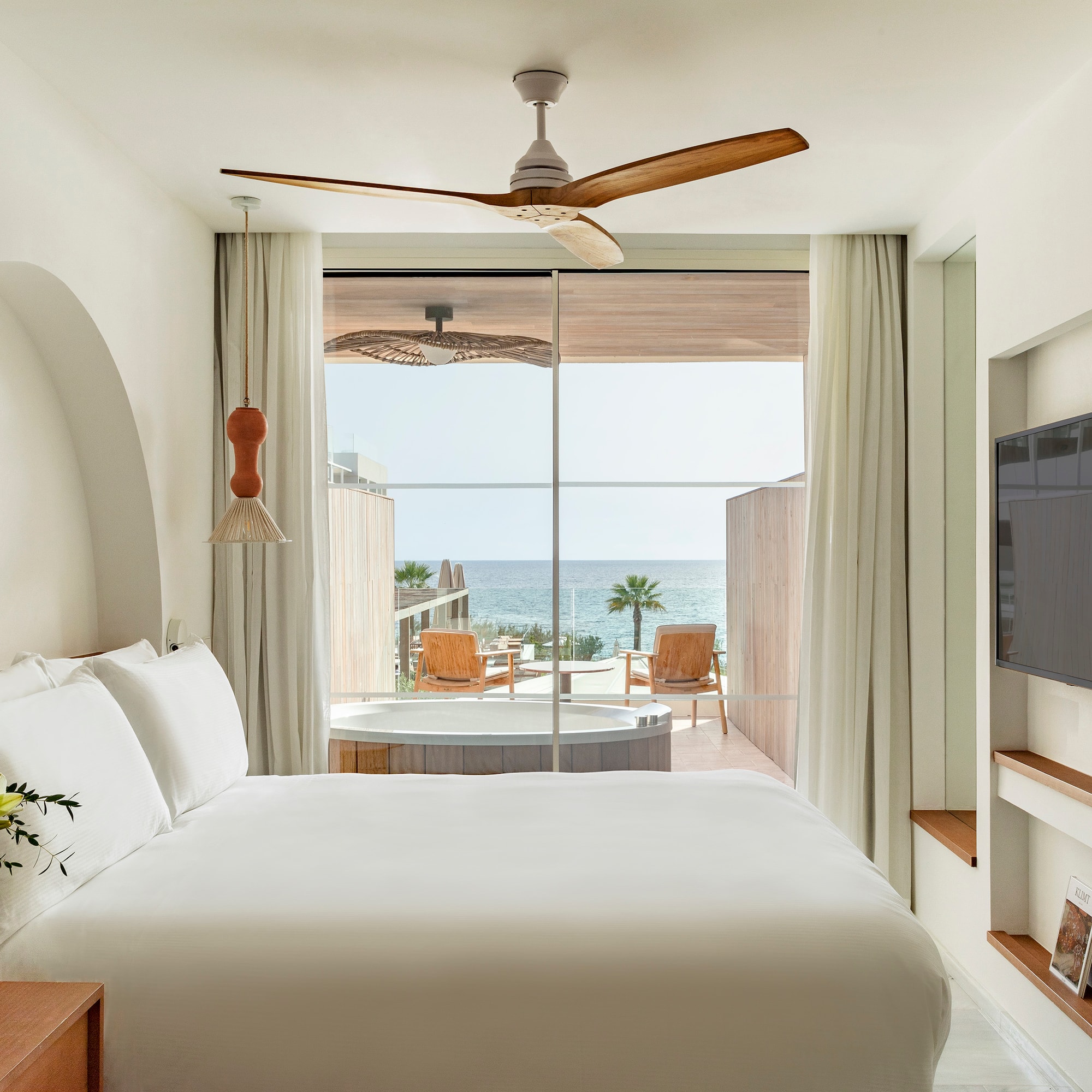 a room with a bed and a television