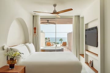 a room with a bed and a television