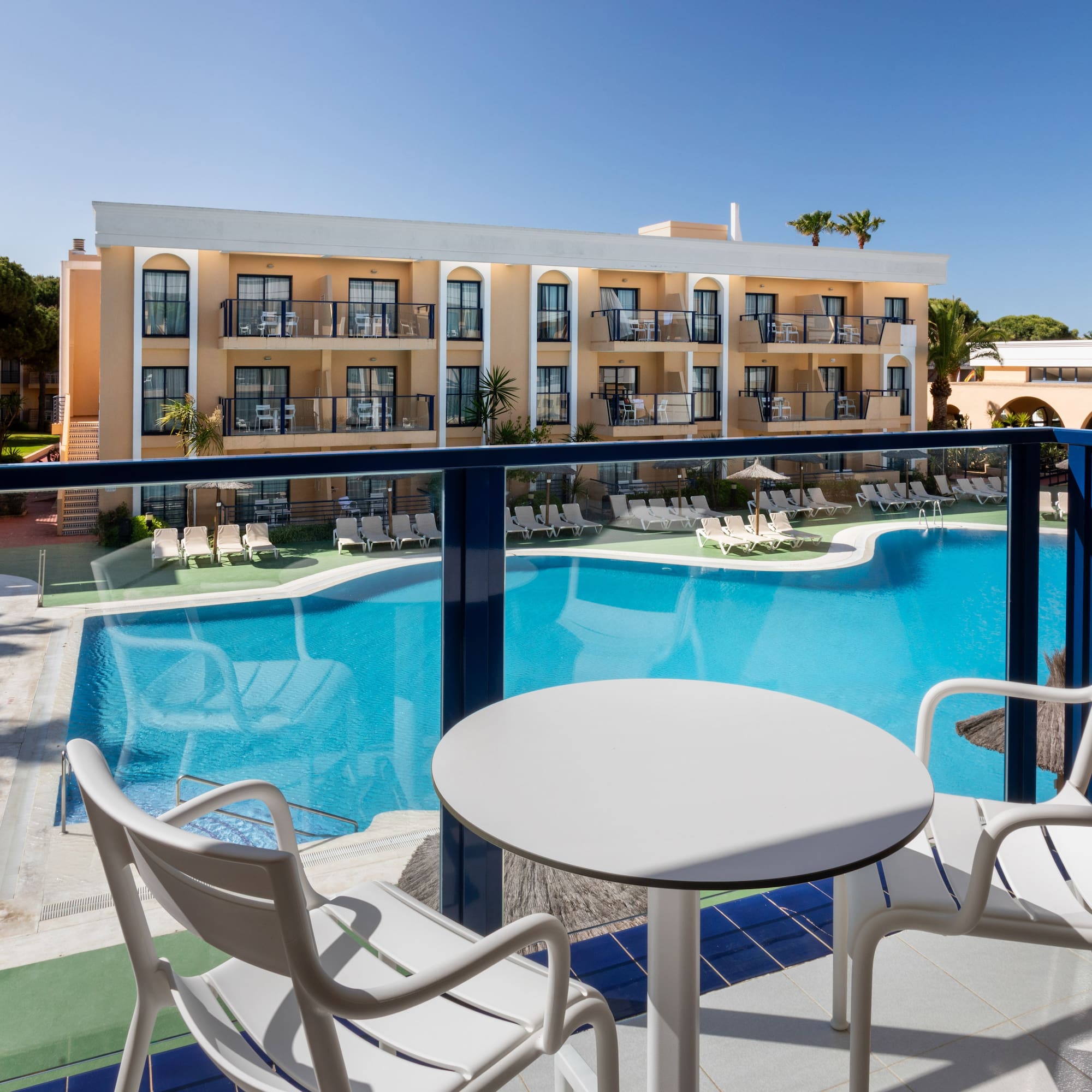 a pool with chairs and tables