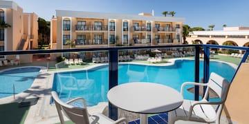 a pool with chairs and tables