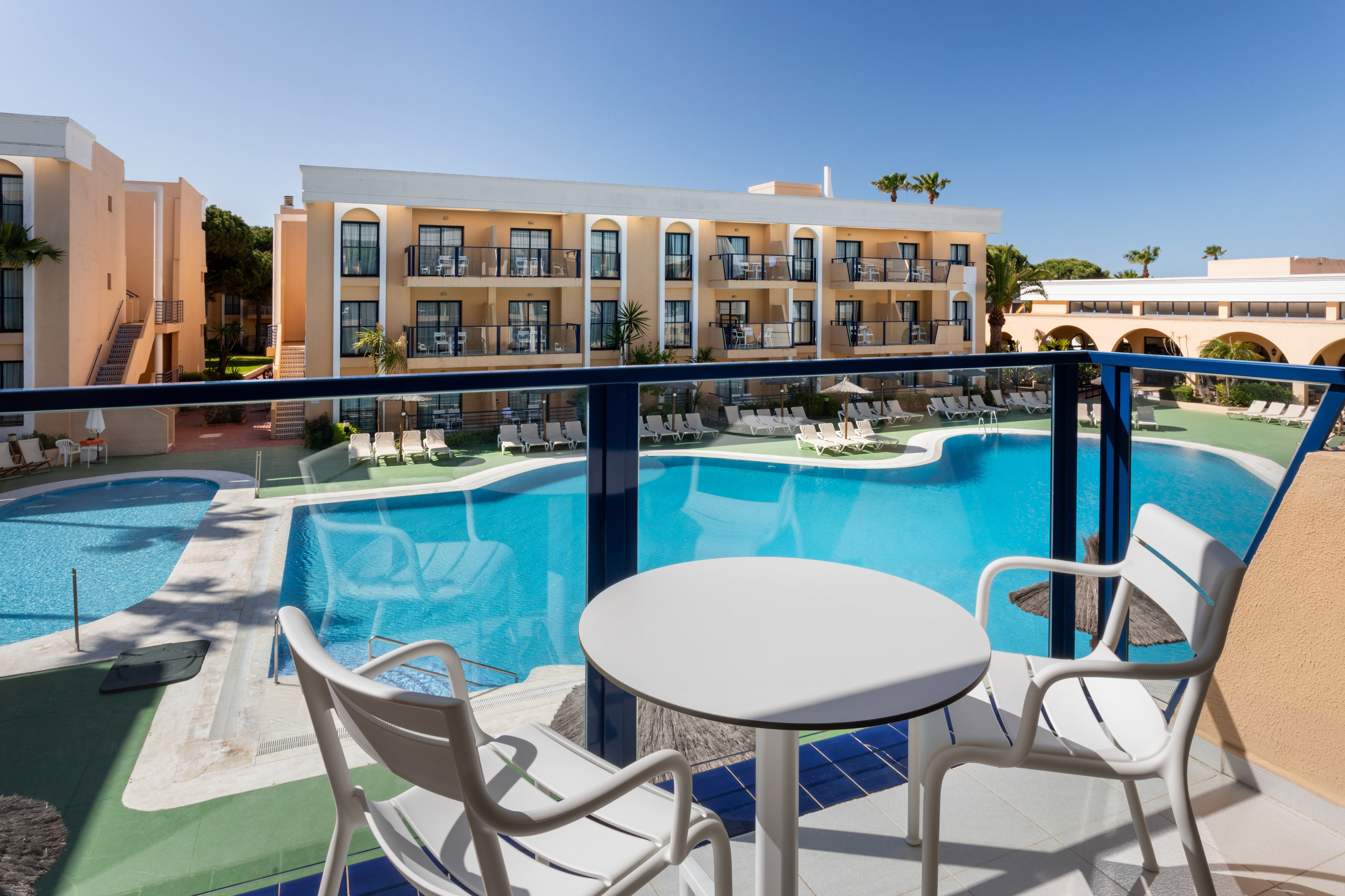 a pool with chairs and tables