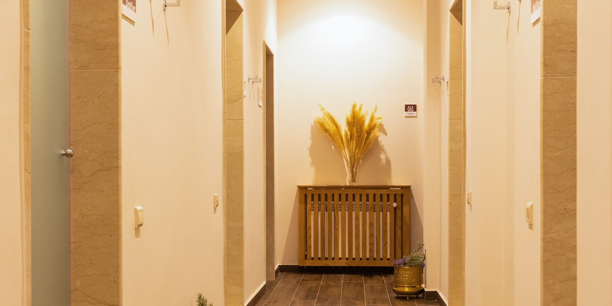 a hallway with plants in pots