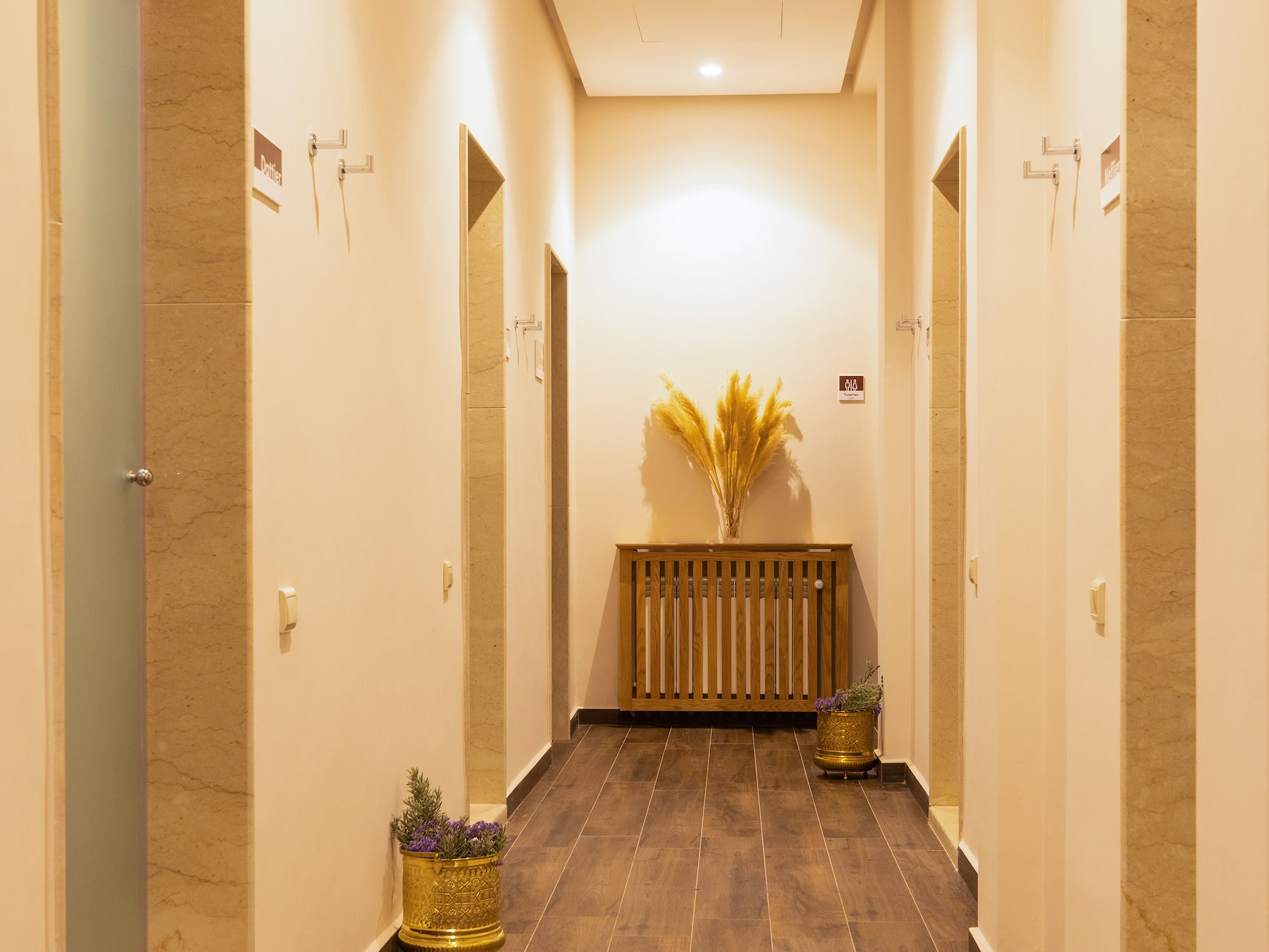 a hallway with plants in pots
