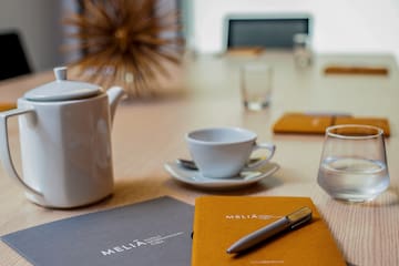 a coffee cup and a pen on a table