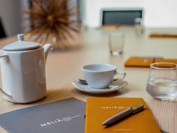 a coffee cup and a pen on a table
