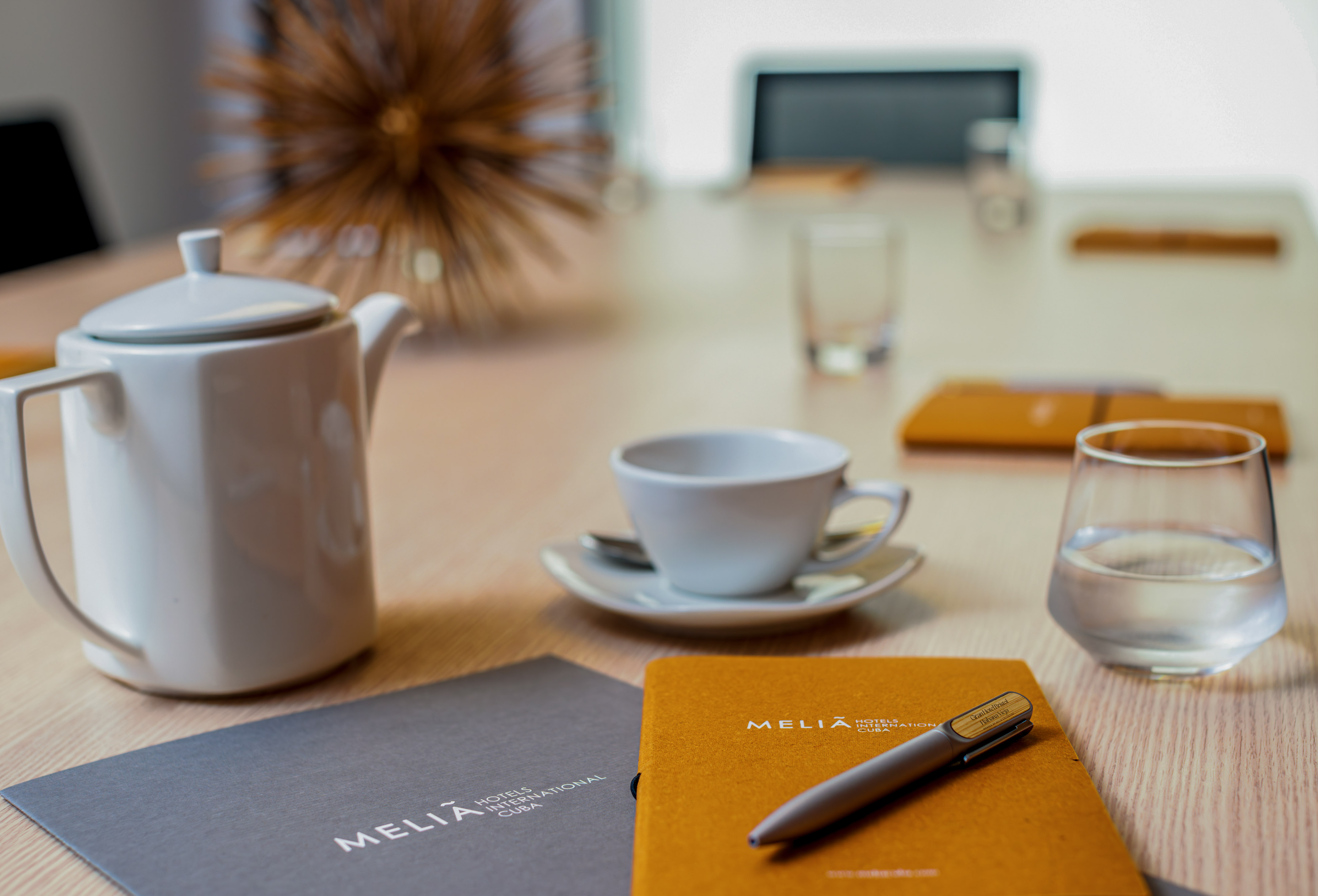 a coffee cup and a pen on a table