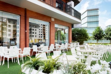 a building with white chairs and tables