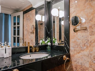 a bathroom with marble walls and a sink