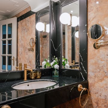 a bathroom with marble walls and a sink