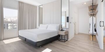 a room with a bed and a mirror