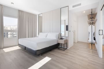 a room with a bed and a mirror