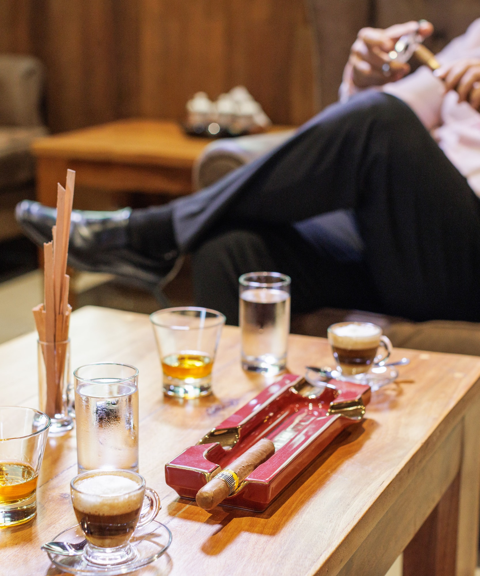 a man sitting on a couch smoking a cigar
