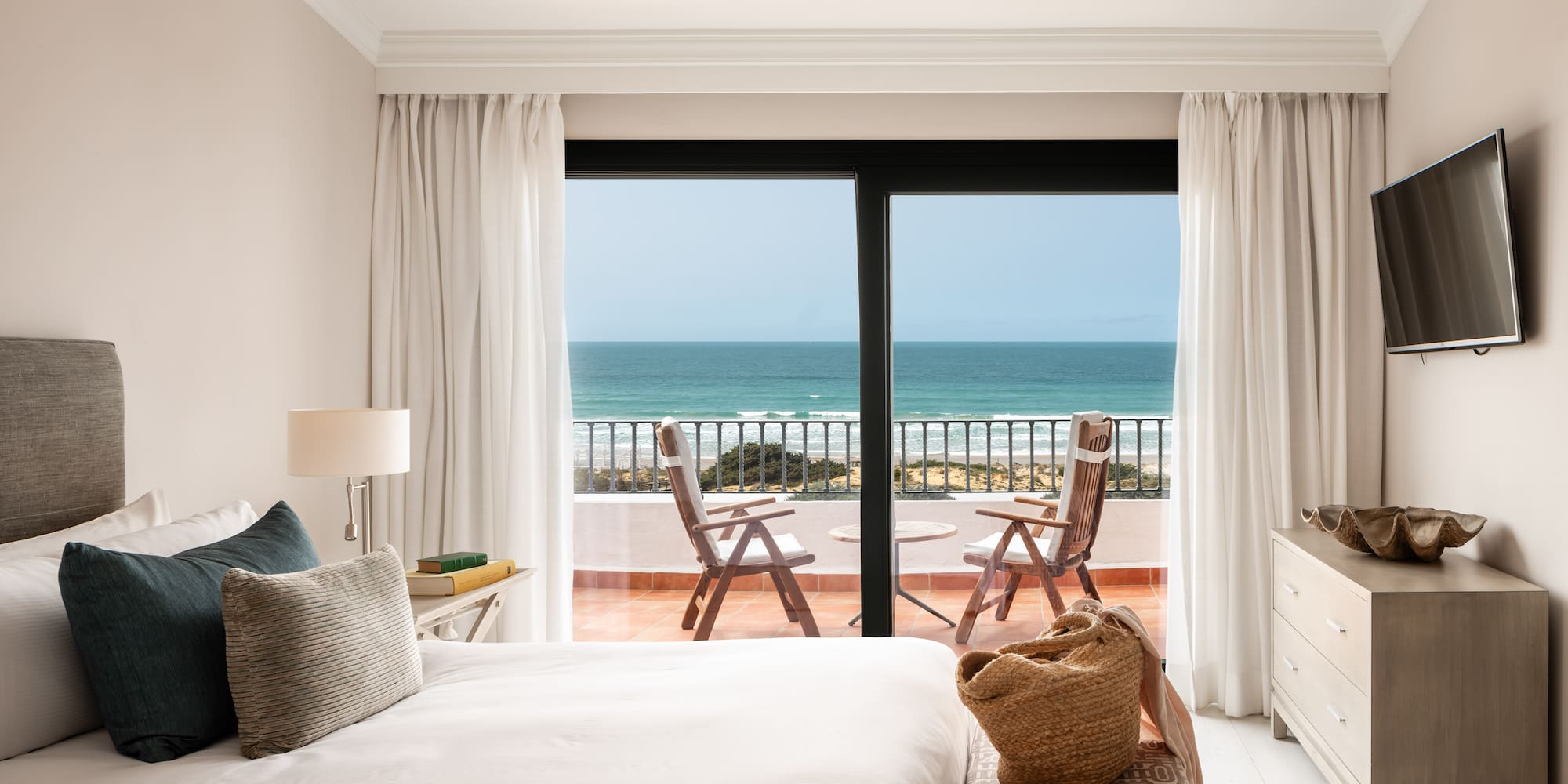a bedroom with a view of the ocean