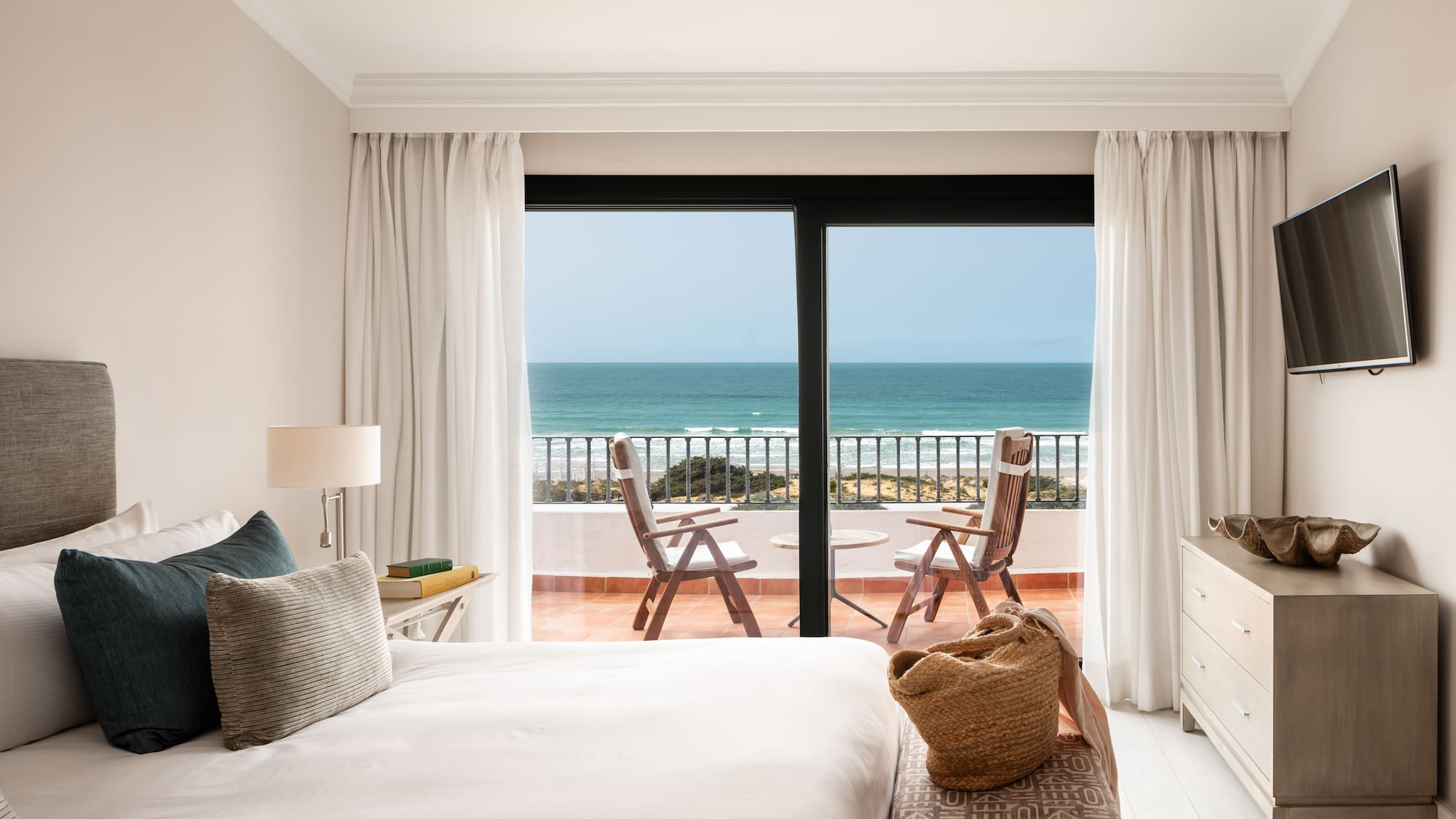 a bedroom with a view of the ocean