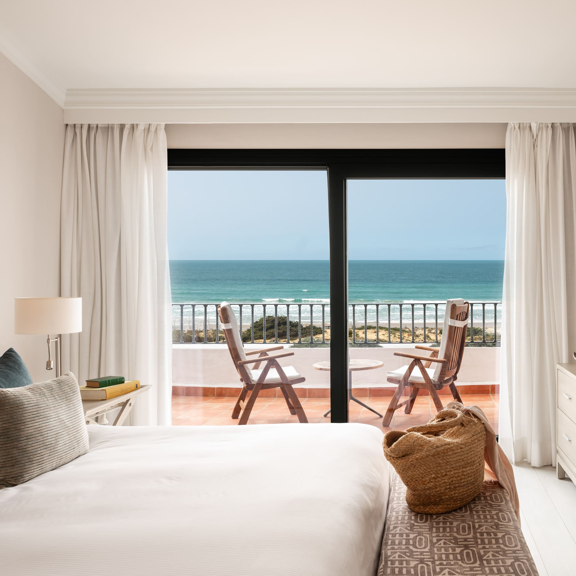 a bedroom with a view of the ocean