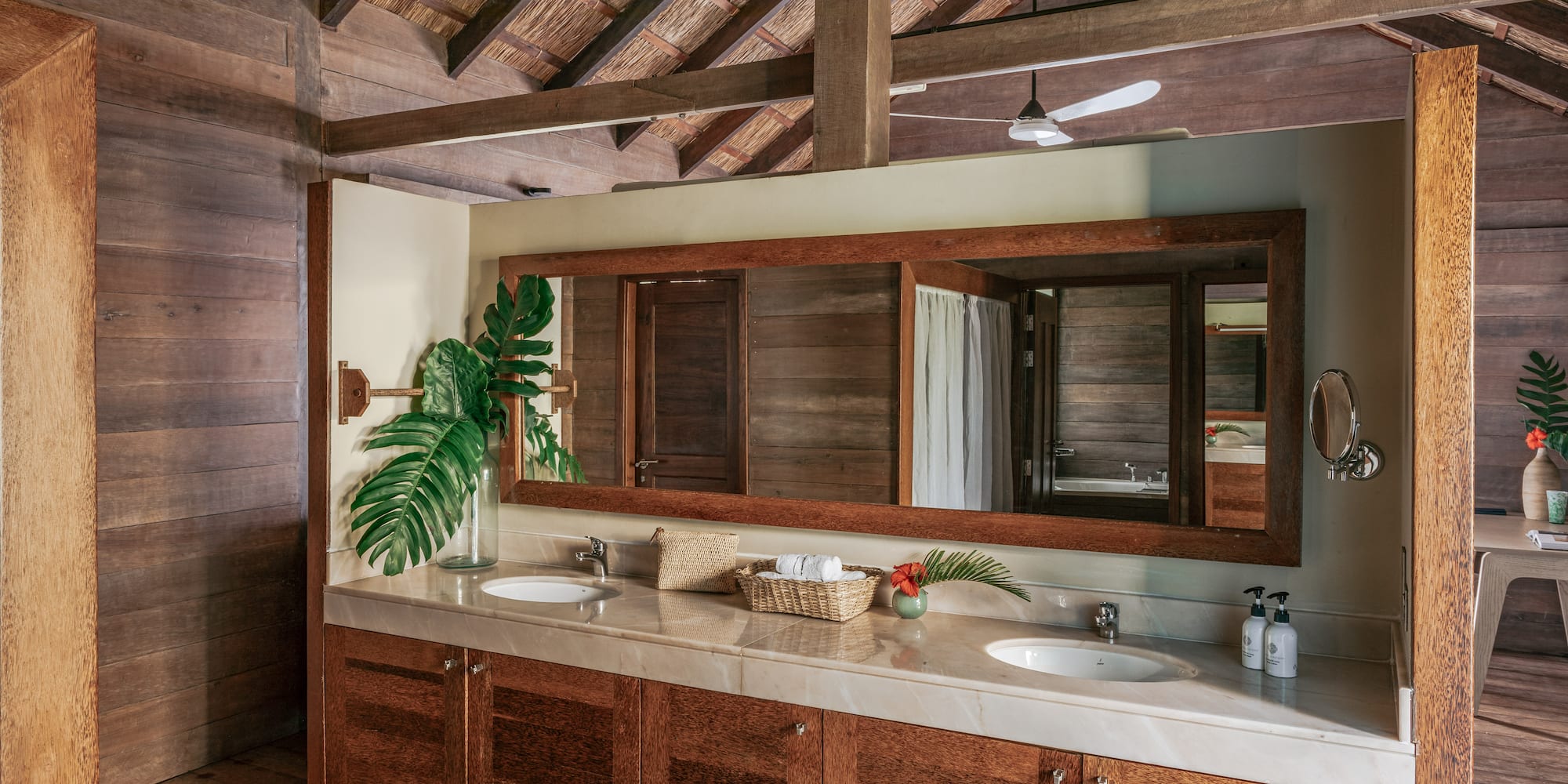 a bathroom with a large mirror and two sinks