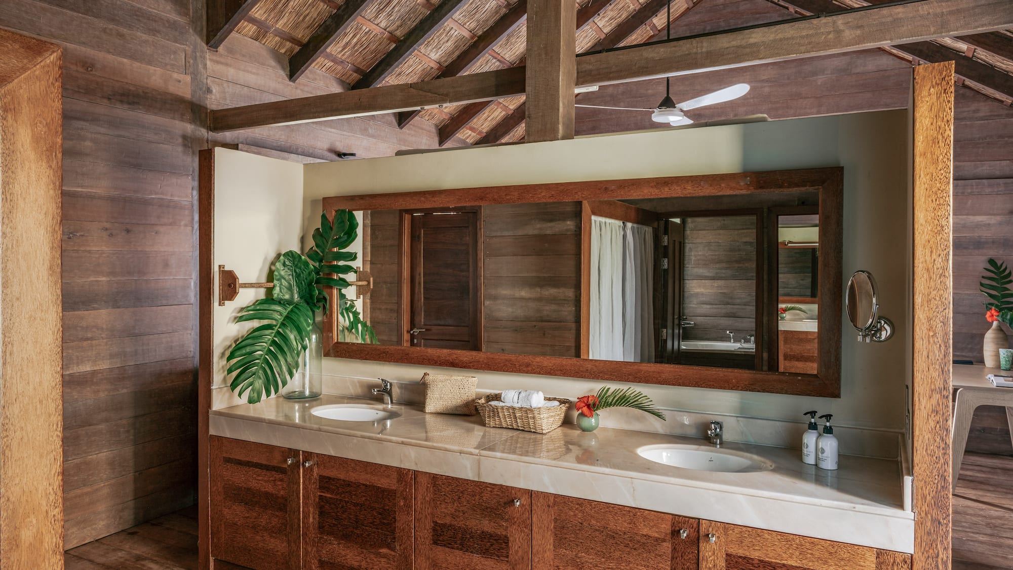 a bathroom with a large mirror and two sinks