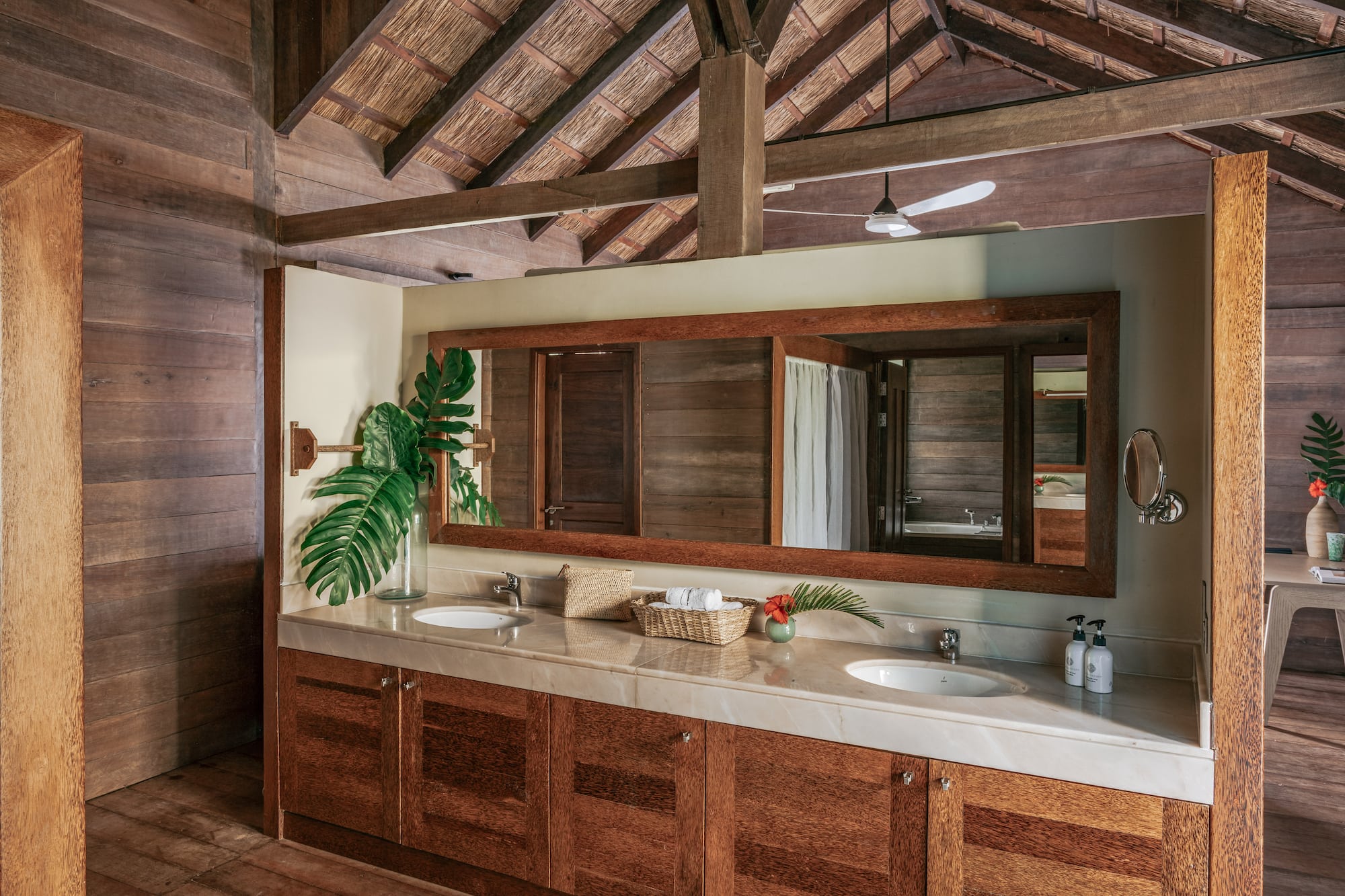 a bathroom with a large mirror and two sinks