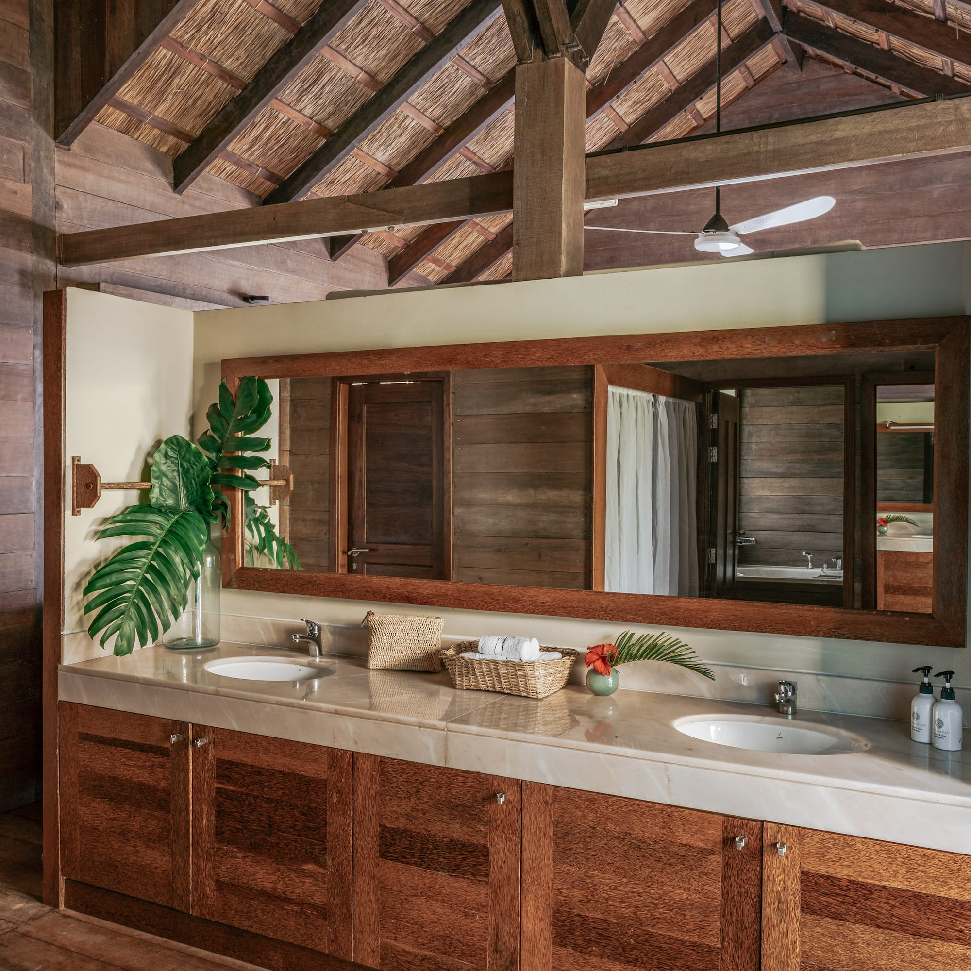 a bathroom with a large mirror and two sinks