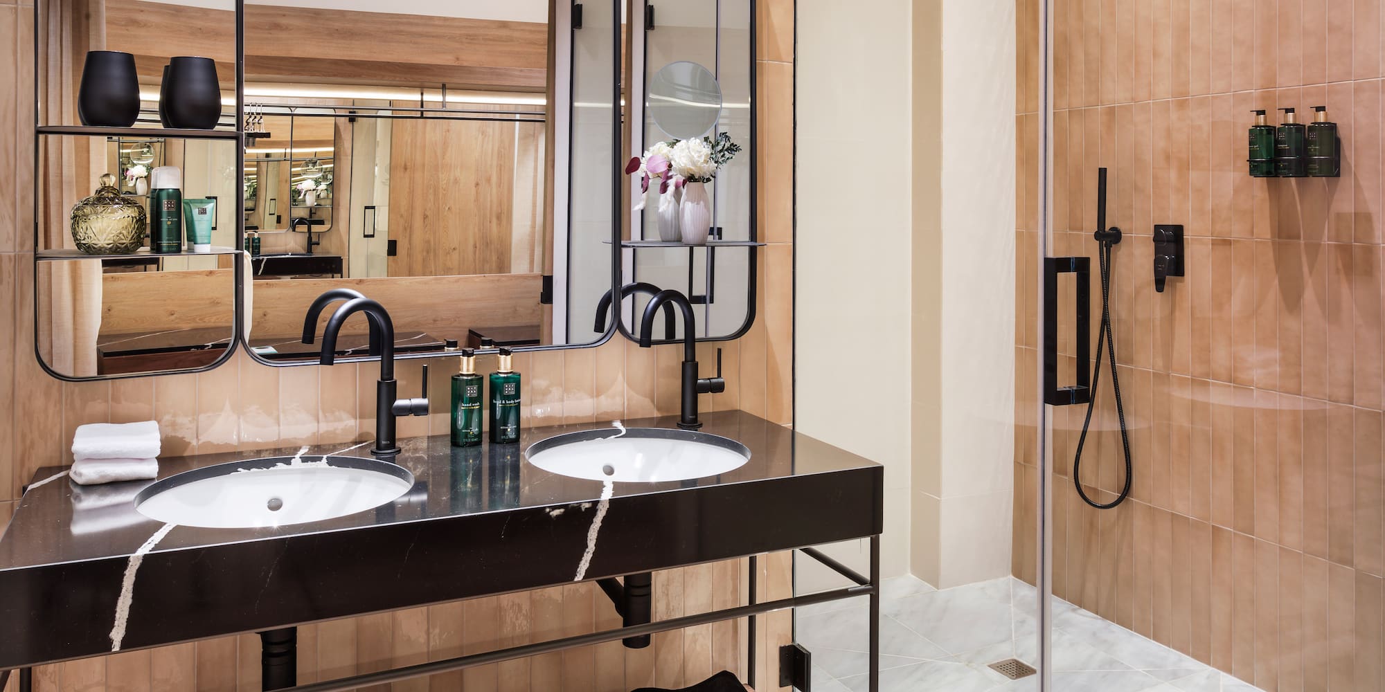 a bathroom with a shower and two sinks