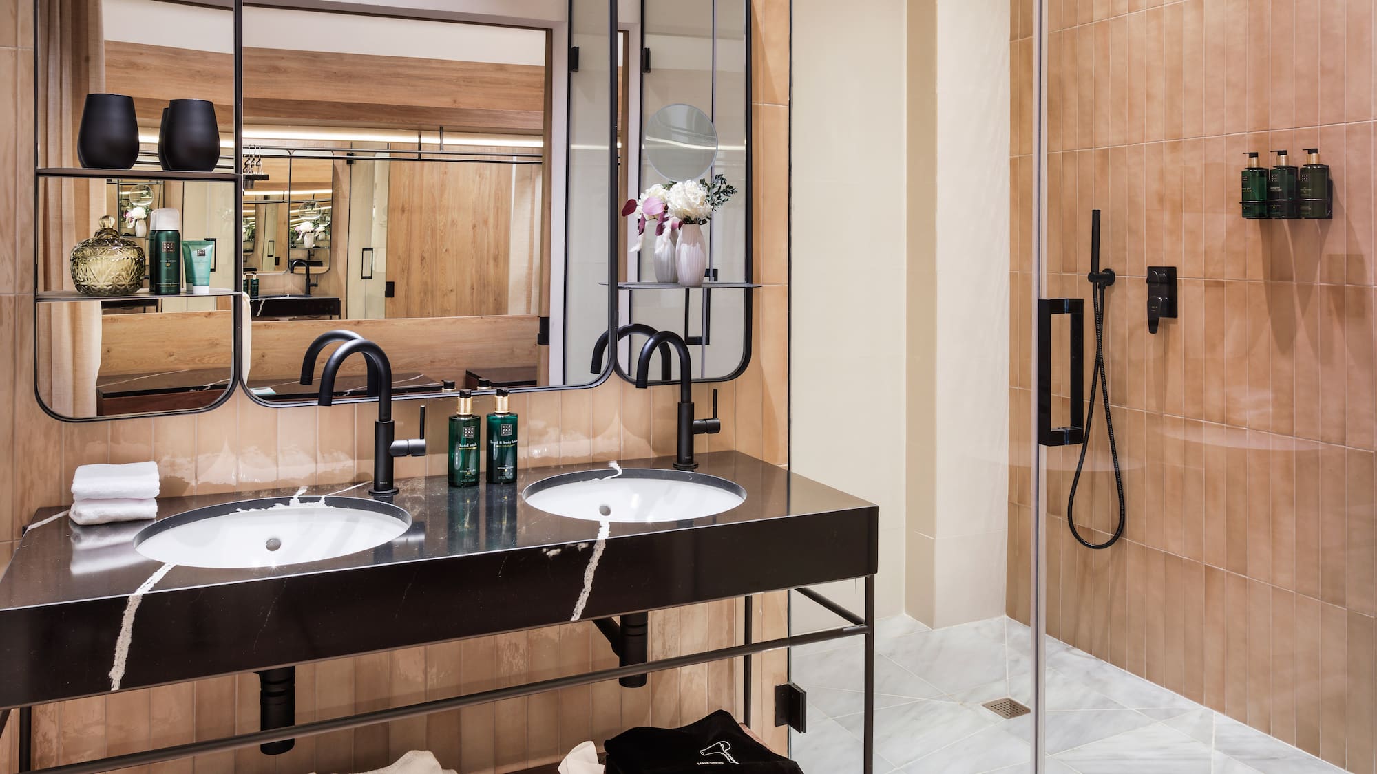 a bathroom with a shower and two sinks
