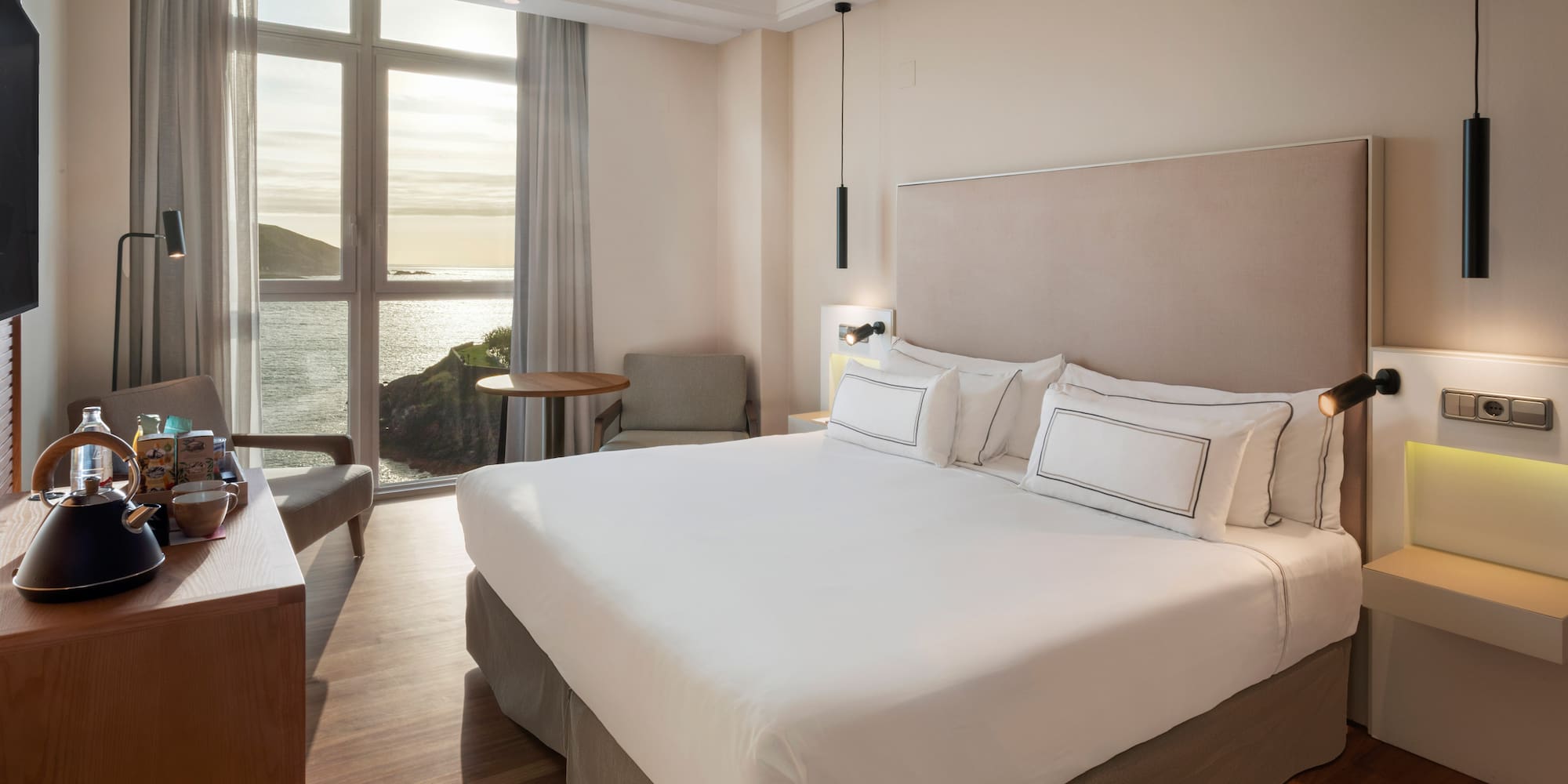 a room with a bed and a table and chairs