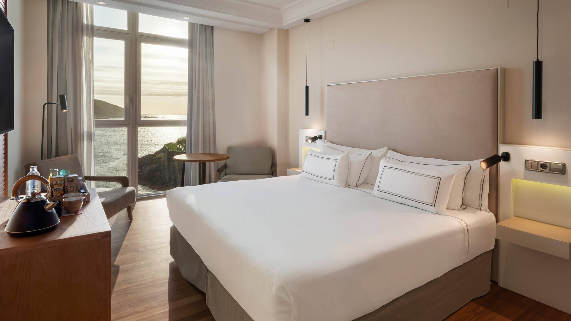 a room with a bed and a table and chairs