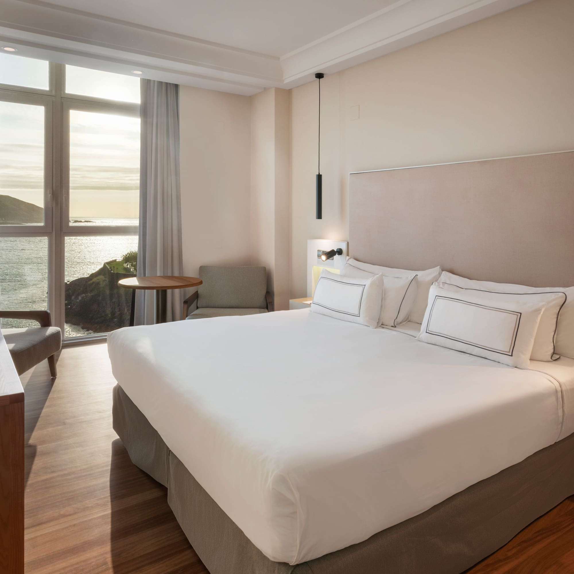 a room with a bed and a table and chairs