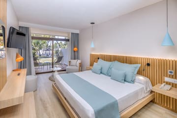 a bedroom with a bed and a chair and a table