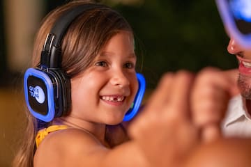 a girl wearing headphones and smiling at a man