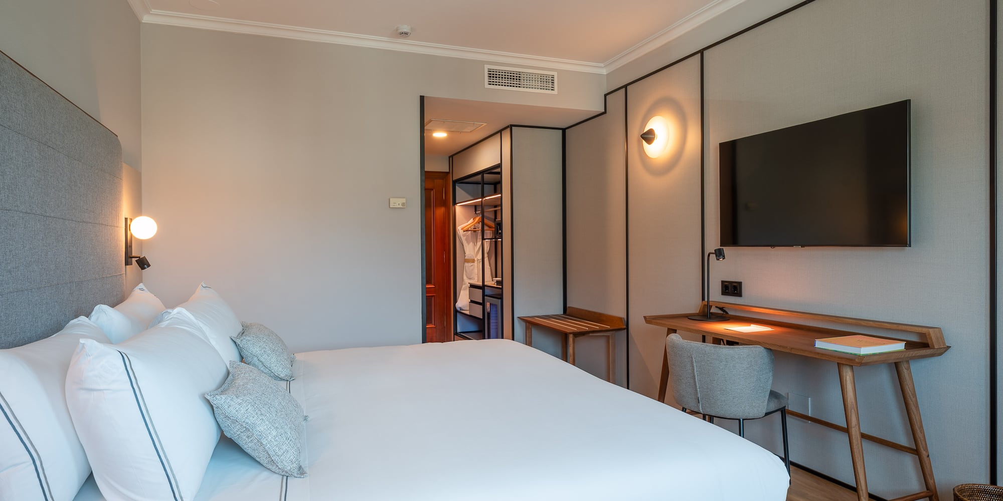 a bedroom with a bed and a tv