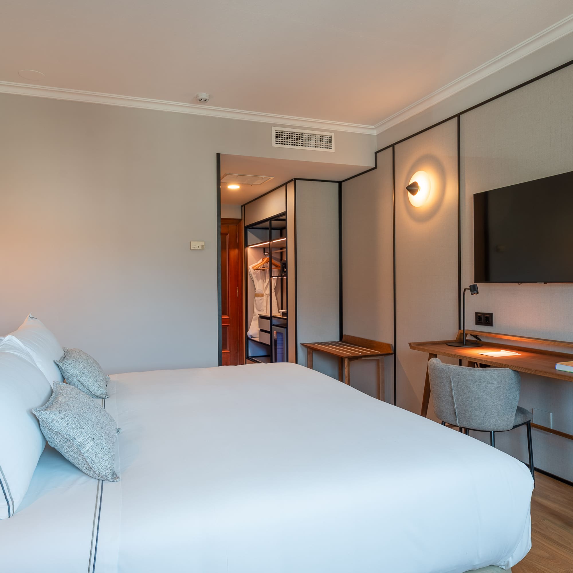 a bedroom with a bed and a tv