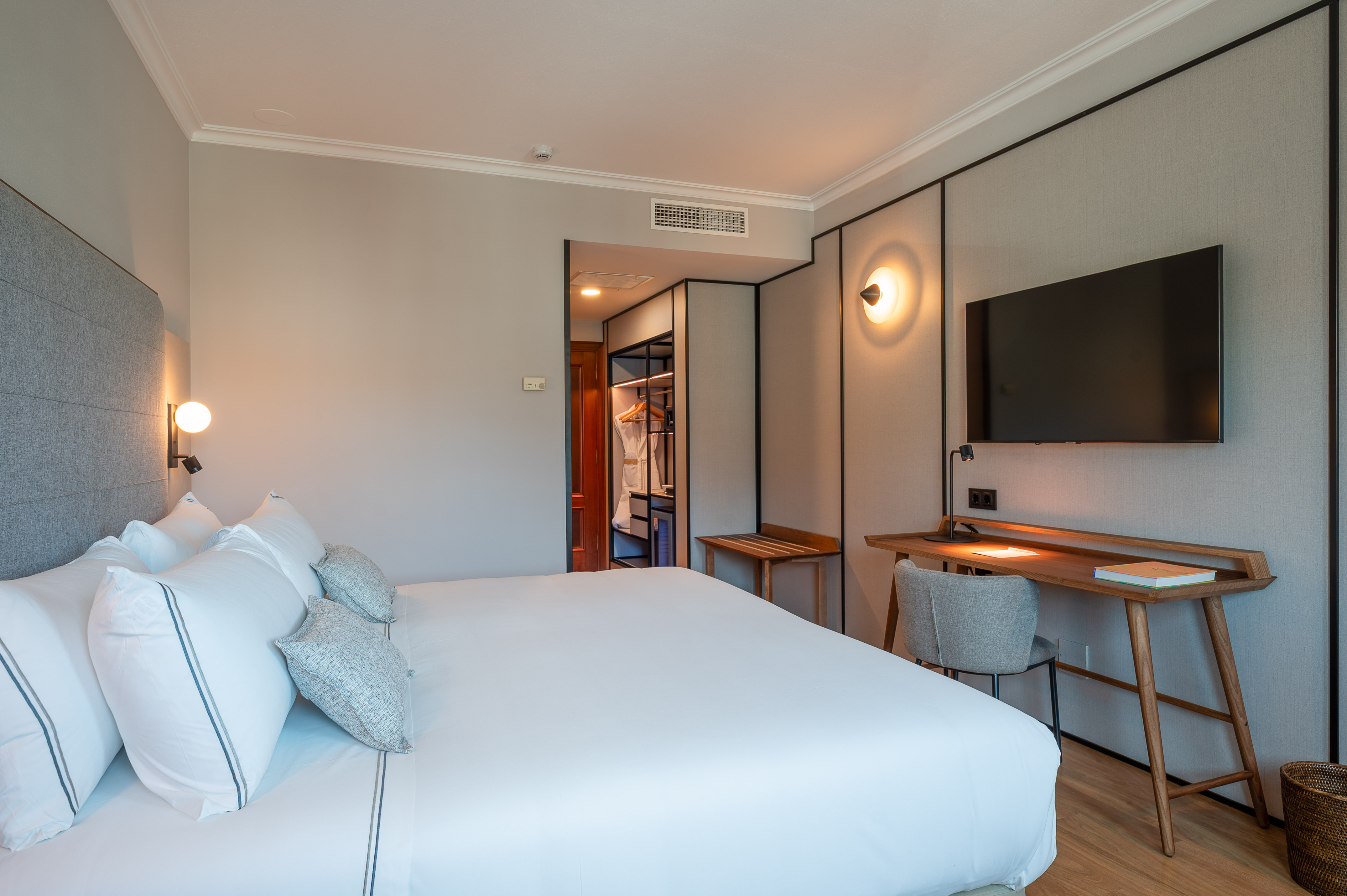 a bedroom with a bed and a tv